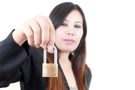 Business hand putting key lock isolated on the white background.の写真素材