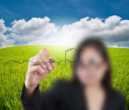 Asian teacher lady writing scientific formula on the blue sky.の写真素材