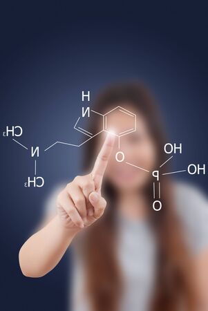 Asian teacher lady pushing scientific formula on the whiteboard.の写真素材