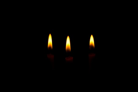 Candle light on the black background.の写真素材