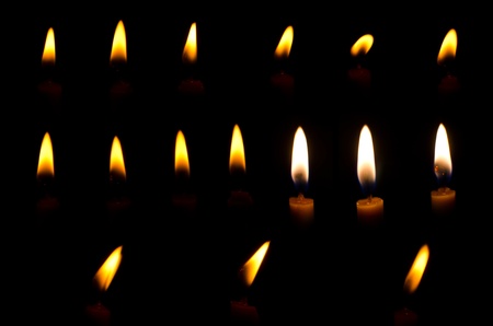 Candle light on the black background.の写真素材