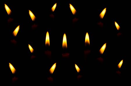 Candle light on the black background.の写真素材
