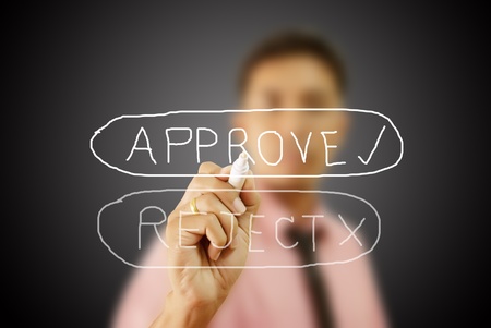 Businessman write Approve word on the whiteboard.の写真素材