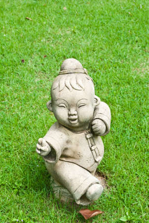 Chinese statue on the grass field in the temple.の写真素材