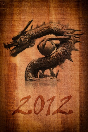 Dragon statue on the wood texture for new year 2012.の写真素材