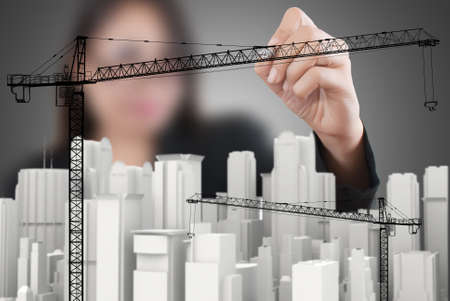 Business Lady drawing Crane line for Construction concept の写真素材