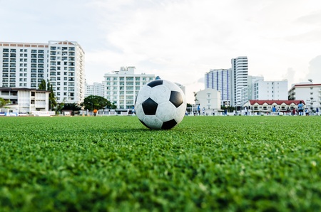 Soccer Football on the green grass of Soccer field with player playing soccer の写真素材