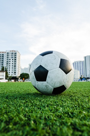 Soccer Football on the green grass of Soccer field with player playing soccer の写真素材