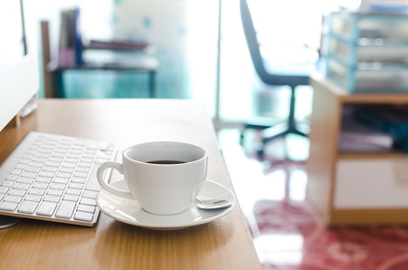 Coffee Cup on the Table with Computer Keyboard for Business Concept の写真素材