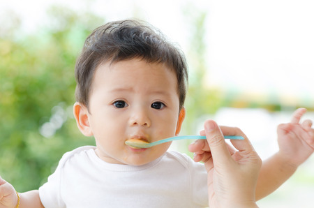 Little Baby Boy Eating in the Park.の写真素材