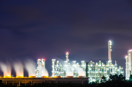 Oil refinery plant at twilight dark blue sky.