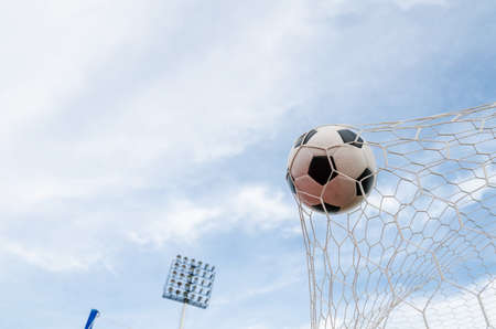 Soccer football in Goal netの写真素材
