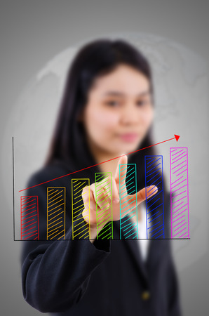 Business lady pushing finance graph for trade stock market on the whiteboard.の写真素材