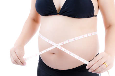 Lovely Young Pregnant Lady isolated on the white background.の写真素材