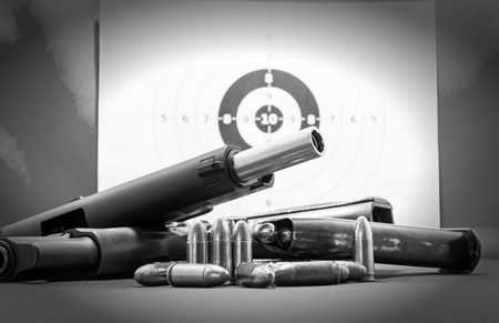 Gun and Bullets on shooting range Isolated on the white background.
