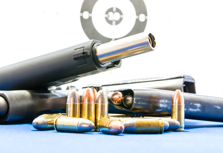 Gun and Bullets on shooting range Isolated on the white background.