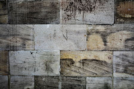 A dirty brick wall with white grey stoneの写真素材