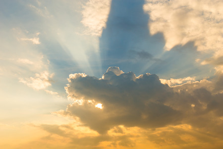dramatic cloud with sunbeams in the skyの写真素材