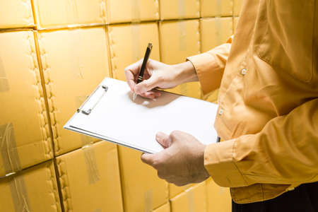 Manager checking stock products in warehouse.の写真素材