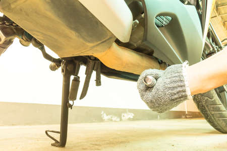 Use screw for motorcycle engine maintenance service, Use Wrench to change engine oil.の写真素材