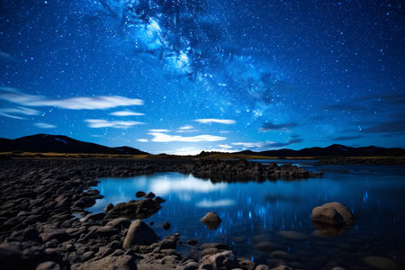Milky Way over a lake with stones and starry sky.の素材