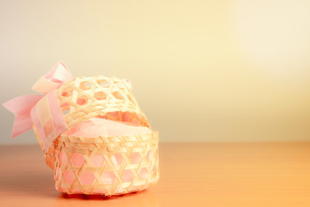Heart shaped gift box with ribbon and bow on wooden table with copy space.の写真素材