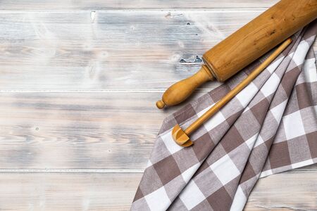 A wooden vintage Table or background with a dish towel and pastry roller, top viewの写真素材