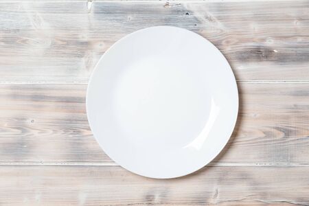 A wooden vintage Table or background with a plate, top viewの写真素材