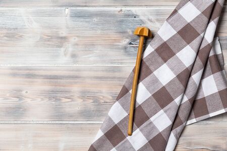 A wooden vintage Table or background with a dish towel and plate, top viewの写真素材