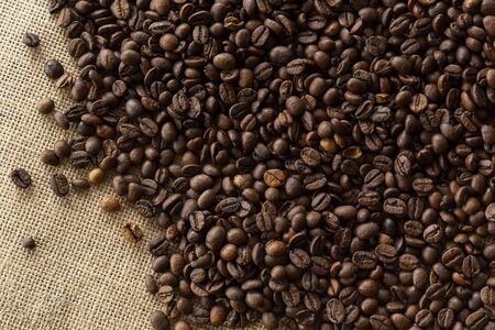 Top view photograph of coffee beans, laying on linen sheet, perfect as backgroundの写真素材