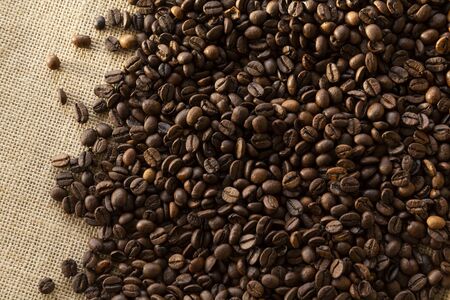 Top view photograph of coffee beans, laying on linen sheet, perfect as backgroundの写真素材
