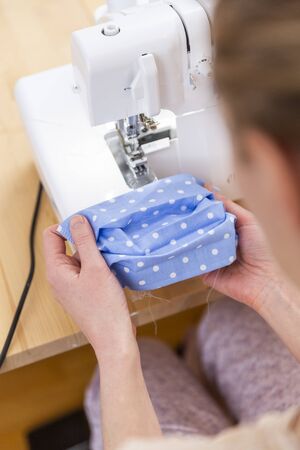 Because of a delivery bottleneck for professional face masks during covid-19 pandemic a lot of people started to organize DIY production of face masks at home.の写真素材