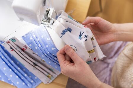 Because of a delivery bottleneck for professional face masks during covid-19 pandemic a lot of people started to organize DIY production of face masks at home.の写真素材
