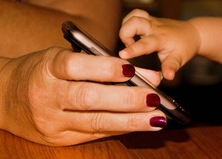 child finger on smartphoneの写真素材