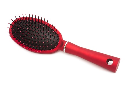 Red hairbrush - it is isolated on a white backgroundの写真素材