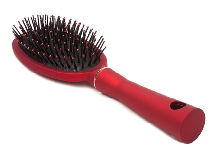 Red hairbrush - it is isolated on a white backgroundの写真素材