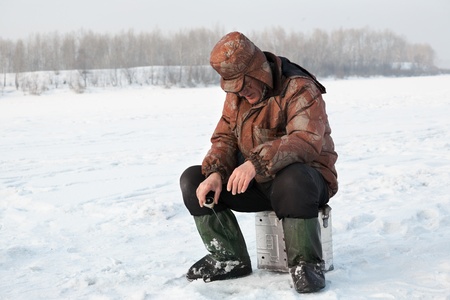 The fisherman on winter fishing fishesの写真素材