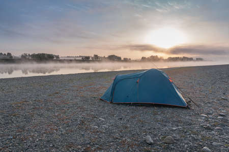 Sunrise while fishing on the riverの写真素材