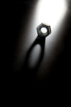 Nut on black surface with bright light and shadowの写真素材