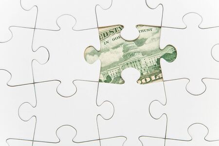 Jigsaw atop of banknote