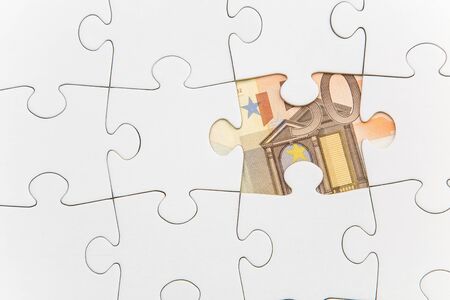 Missing jigsaw piece showing a banknoteの写真素材