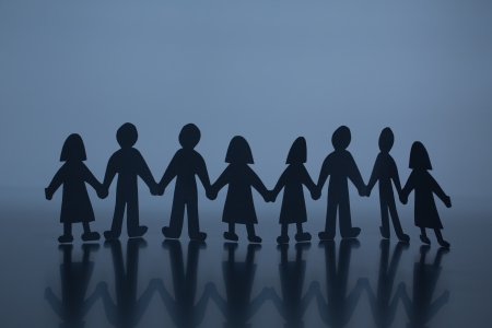 silhouette of chain of paper cut peopleの写真素材