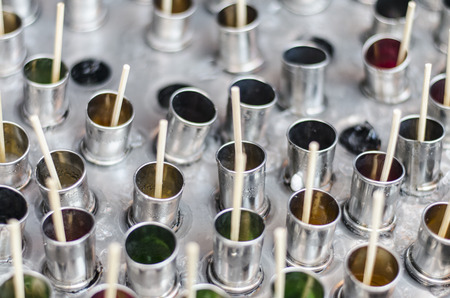 The Thai ice scream made by using juice pour to stainless tube and soak into a big can filled by many iceの写真素材