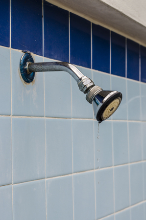A faucet place on ceramic tile wallの写真素材