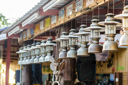 And image of a lot of old oil lamp that hanging from roofの写真素材