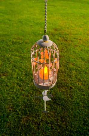 Closeup image of an imitation white candle in a cage. The decoration of the wedding in the night.の写真素材
