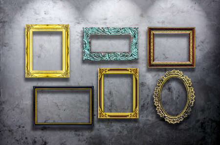 An image of a lot of wooden photo frame on concrete wall whit ceiling lightの写真素材