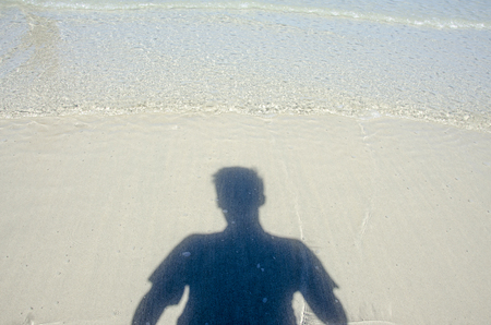 An image of a shadow om man on the beach in the seaの写真素材