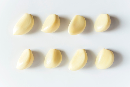 Garlic cloves on white background fresh and clean from farmの写真素材