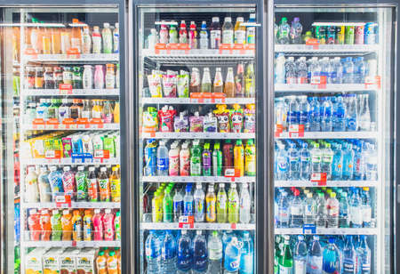 HANOI,VIETNAM - March 1,2021 -Variety of soft drinks,energy drinks,sport drinks,drinking water and fruit juice on Freezer shelves at grocery store supermarketのeditorial素材